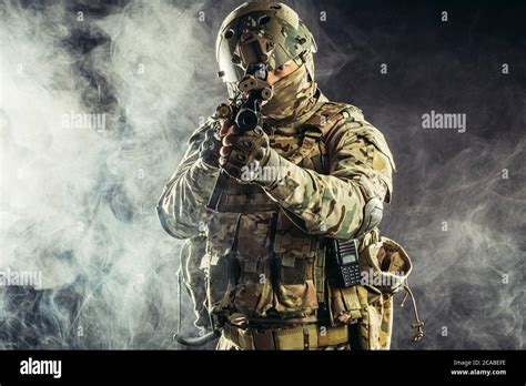 military forces concept., young brave soldier holding weapon looking ...