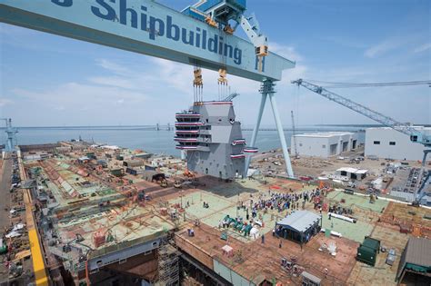 The island of the aircraft carrier USS John F. Kennedy (CVN 79) is landed onto the flight deck ...