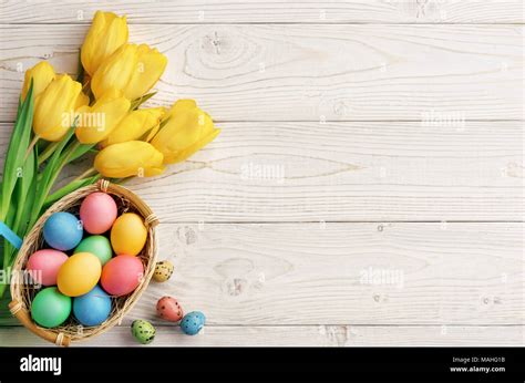 Easter background with Easter eggs and spring flowers. Top view with ...