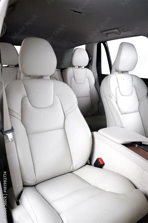 Luxury car inside. Interior of prestige modern car. Comfortable leather seats. White leather ...