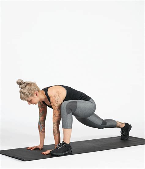 a woman in grey leggings and black top doing a push up