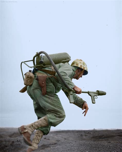 A Marine flamethrower operator moves forward to assault a Japanese pillbox on Motoyama Airfield ...