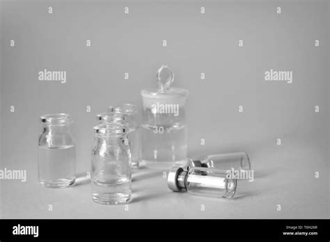 Small glass bottles on light background Stock Photo - Alamy