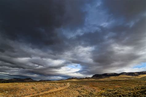 Overcast sky over vast valley and hilltops · Free Stock Photo