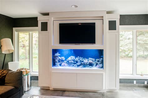 Built-in Saltwater fish tank cabinetry with flip up flat screen tv.