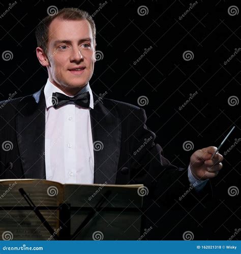 Orchestra Conductor in Black Tuxedo in Dark Studio Stock Photo - Image of shirt, suit: 162021318