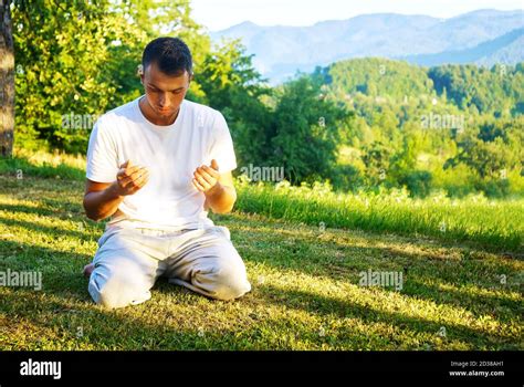 Muslim adult man praying outdoor at natrual environment sun beams Stock ...