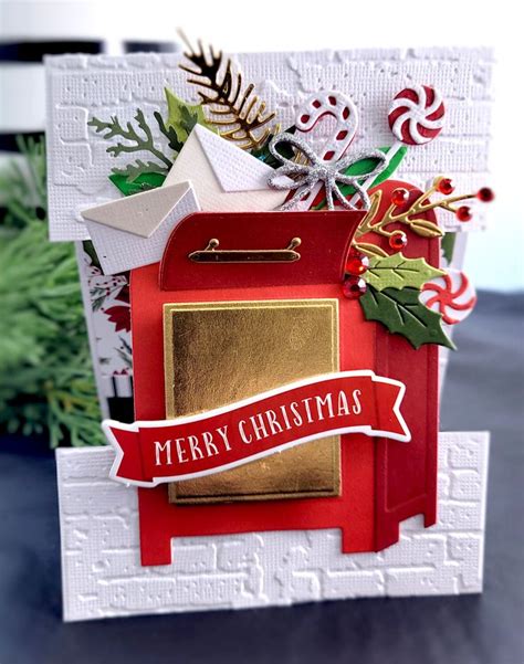 a christmas card with a red mailbox and gold foil stamping on the front