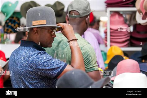 Man trying on a hat in a hat shop Stock Photo - Alamy