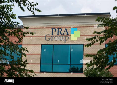 A logo sign outside of the headquarters of the PRA Group, Inc., also ...