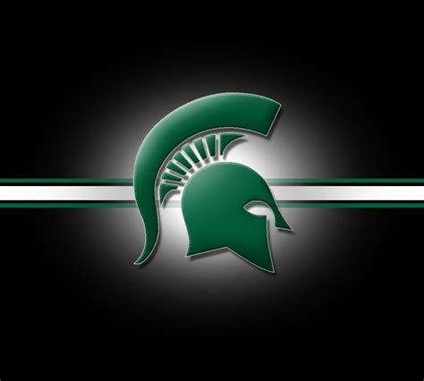 the michigan state green and white logo on a black background with ...