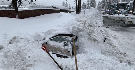 Snowplow finds woman in snow-covered car