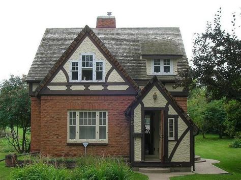 Charming Tudor Home with White Trim and Brown Shingles