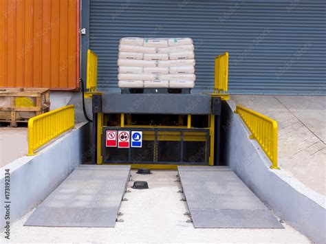 Loading dock leveler ramp outside warehouse building for loading and unloading cargo,Part of ...