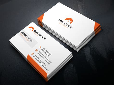 two orange and white business cards sitting on top of a black table next to each other