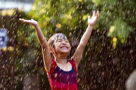 Free Photo | Asian children playing in the rain are happy.