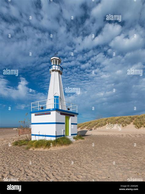 New Buffalo Lighthouse and beach under cloudy sky in New Buffalo ...