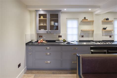 Honed black African granite worktop with chrome cup handles on the grey shaker cabinetry make up ...