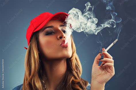 Beautiful young woman smoking cigarette Stock Photo | Adobe Stock