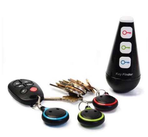 the key finder is next to several car keys and a black remote control case