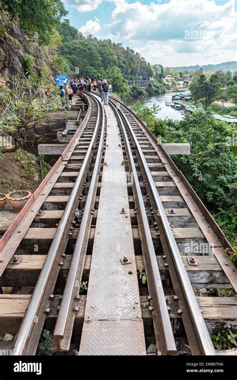 Tourists walking on the wooden death railway bridge at Tham Krasae ...