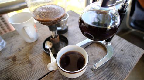 Fresh brewed cup of coffee on table next to Siphon coffee brewer. Siphon Coffee, Coffee Cups ...