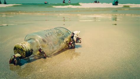 An empty glass bottle on a beach - PixaHive