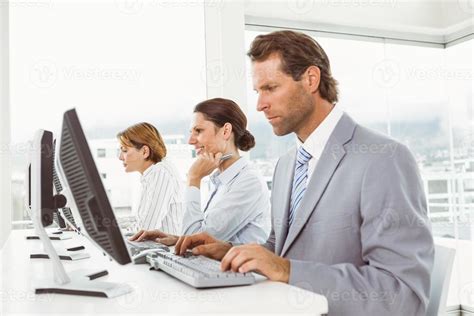 Business people using computers in office 864967 Stock Photo at Vecteezy