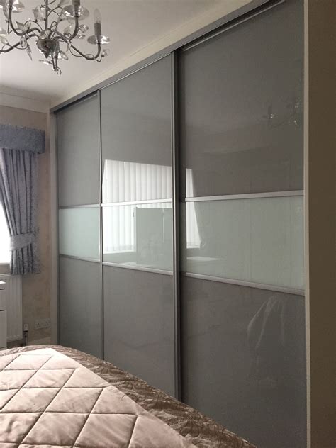 One of our multi panel grey glass sliding door wardrobes. | Wardrobe door designs, Sliding door ...