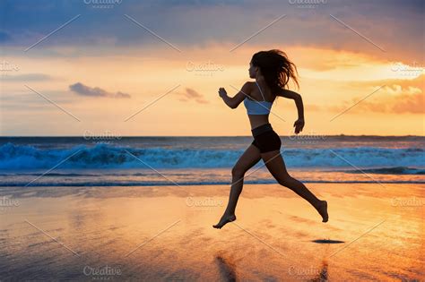 Girl running by sunset beach | Sports & Recreation Stock Photos ~ Creative Market