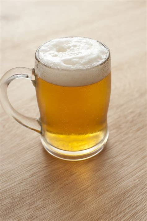 Tankard of beer with a frothy head - Free Stock Image