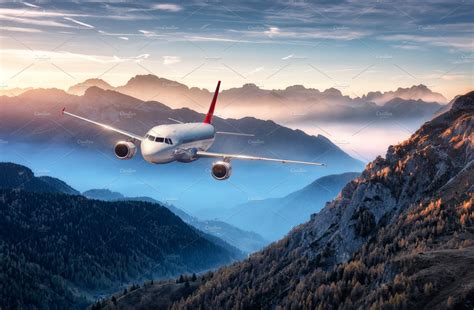 Airplane is flying over mountains stock photo containing airplane and ...