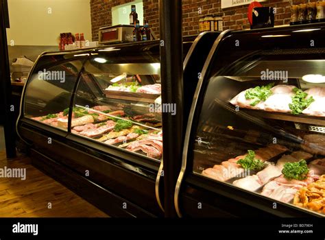 Glass fronted meat display cooler cases in butcher shop Stock Photo - Alamy