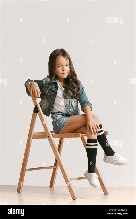 Full length portrait of cute little kid girl in stylish jeans clothes ...