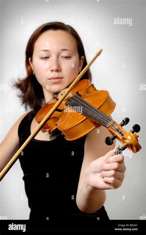 Girl tuning violin isolated Stock Photo - Alamy