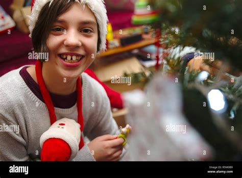 Happy child decorating Christmas tree Stock Photo - Alamy