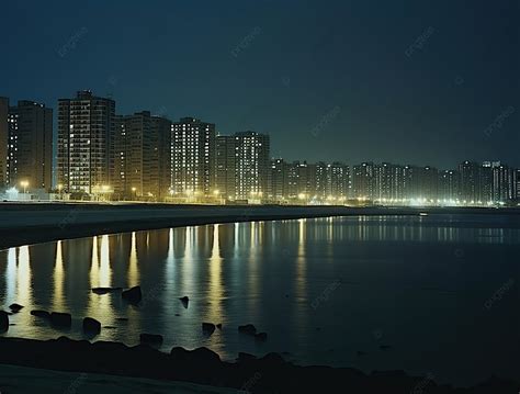 Cityscape With Night Lights At The Beach Reshot From The Shore ...