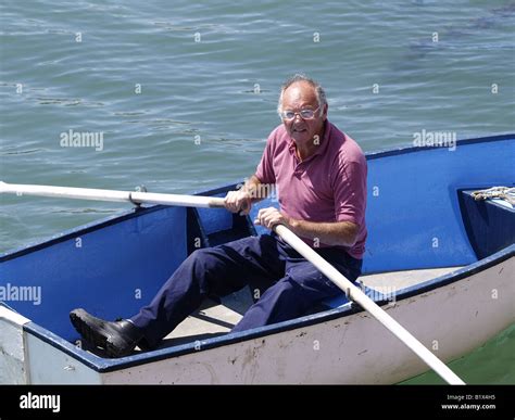 Old man in a rowing boat Stock Photo - Alamy