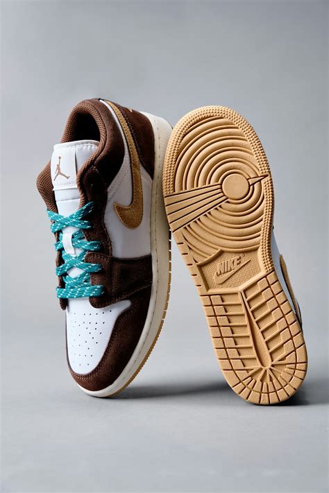 A pair of brown and white sneakers with blue laces photo – Free Shoe ...