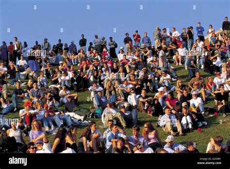 CROWD OF PEOPLE SITTING OUTSIDE ON GRASS SLOPE Stock Photo: 156849 - Alamy