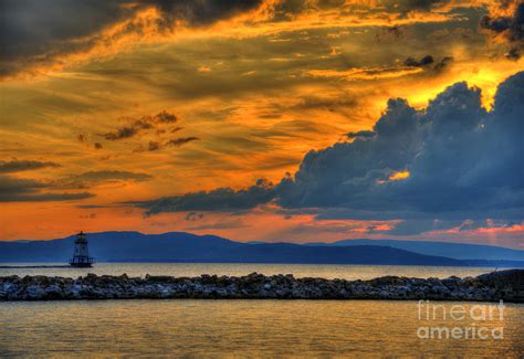 Lake Champlain lighthouse in a deep sunset Photograph by Daniel Reiner - Fine Art America