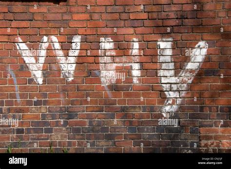 Graffiti on a red brick wall Stock Photo - Alamy