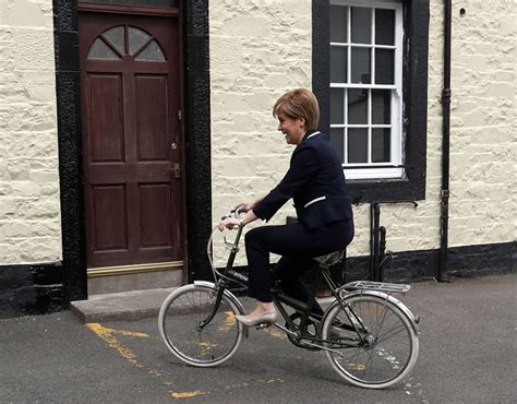 First Minister and SNP leader Nicola Sturgeon has a shot on a bike during a visit to Moffat on ...