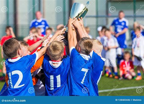 Young Soccer Players Holding Trophy. Boys Celebrating Soccer Football Championship Editorial ...