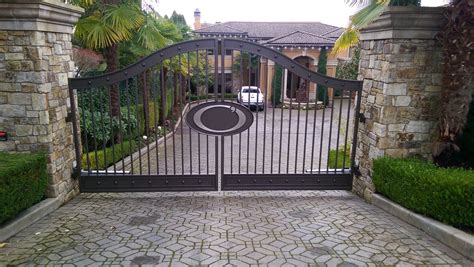 Custom double swing gate with bronze finish, double channel rails with steel plate infill and ...