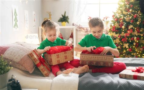 children opening Christmas presents Stock Photo by choreograph | PhotoDune