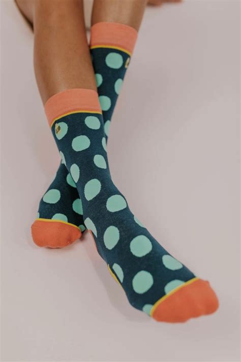 Polka dots for the win, every time. Bright aqua polka dots spot these navy socks and add a ...