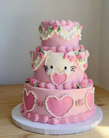 a three tiered cake with hello kitty on top