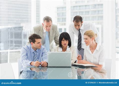 Business People Gathered Around Laptop Talking Stock Image - Image: 37396351