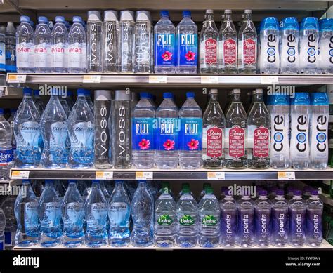 Rows of name brand bottled waters on grocery store shelves Stock Photo - Alamy